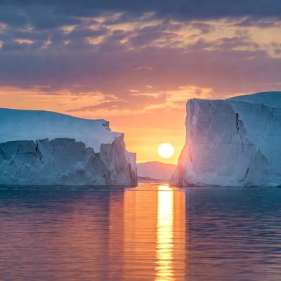 Sunset over icy landscape in water