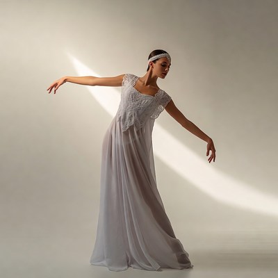 Model poses in white dress during photo shoot