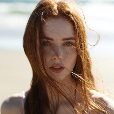 Young woman on beach with wind in hair