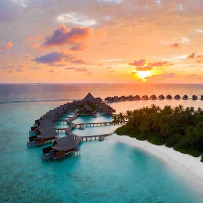Sunset over tropical resort in maldives