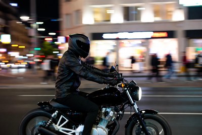 Motorcyclist rides through city street