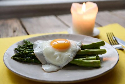 Eggs on asparagus with candlelight