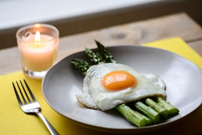 Egg on asparagus with candlelight