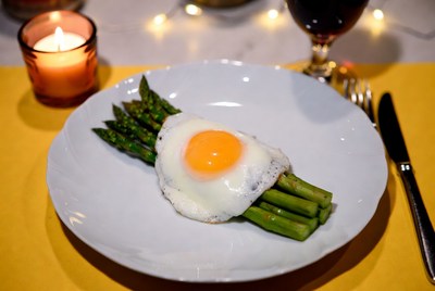 Asparagus with fried egg on plate