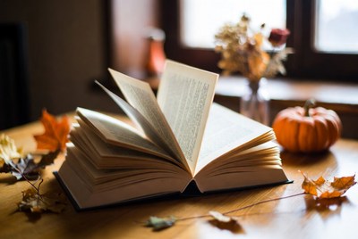 Open book on a table with autumn decor