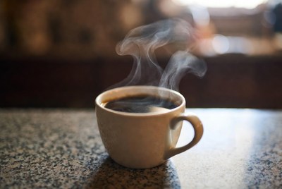 Steaming coffee cup on kitchen counter