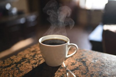 Hot coffee on a table by a window