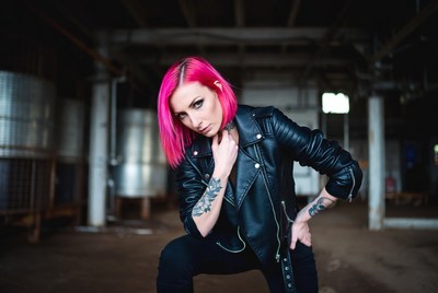 Woman with pink hair in factory