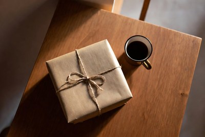 Gift box and coffee on table