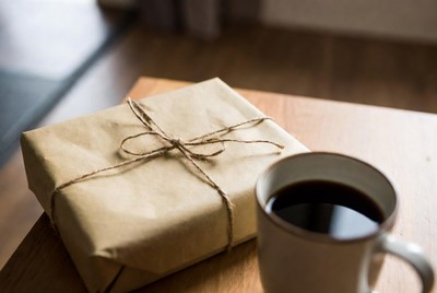 Coffee and wrapped package on table