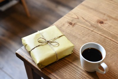 Gift and coffee on a wooden table