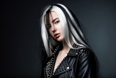 Woman with unique hairstyle poses in studio