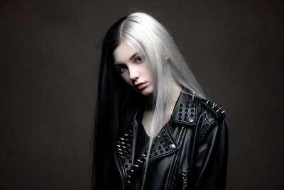 Model in black and white hairstyle poses