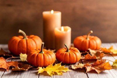 Autumn pumpkins and candles on wood