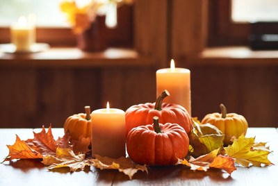 Pumpkin display with candles and leaves