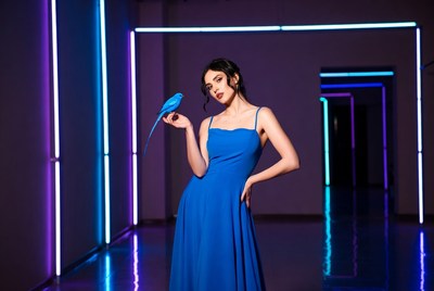 Model in blue dress with bird