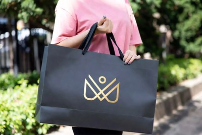 Person holds shopping bag outdoors