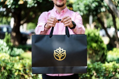 Man holding shopping bag outdoors