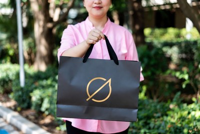 Woman holding bag in garden