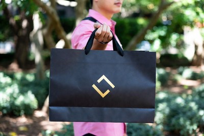 Man holding shopping bag outdoors