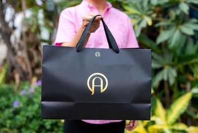 Person holding a black shopping bag