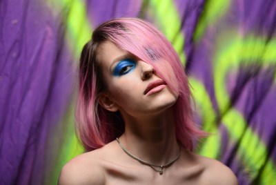 Model poses near colorful graffiti wall