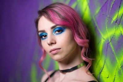 Model posing near colorful wall