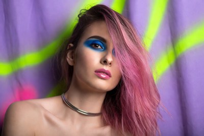 Woman with pink hair and bold makeup