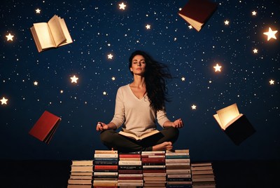 Woman meditating surrounded by books