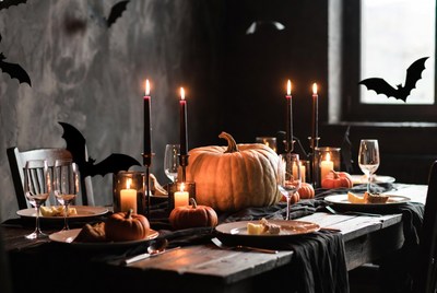 Halloween dinner setting with pumpkins and candles