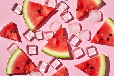 Watermelon and ice on pink surface