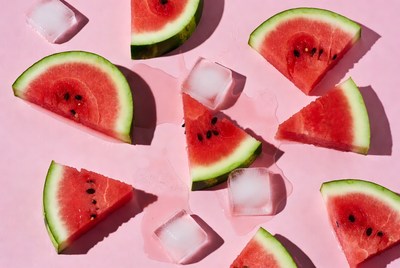 Fresh watermelon and ice on pink background