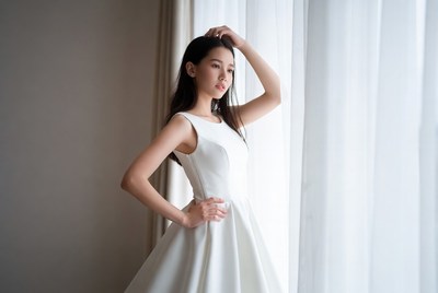 Model posing by large window