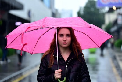 Walking in the rain with an umbrella