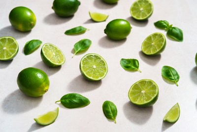 Fresh limes and basil on a surface