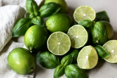 Fresh limes and basil on a table