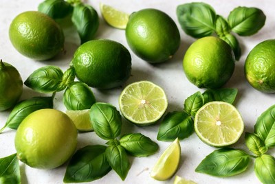 Fresh limes and basil on a surface