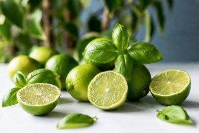 Limes and basil on table