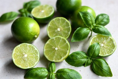 Fresh limes and basil on countertop