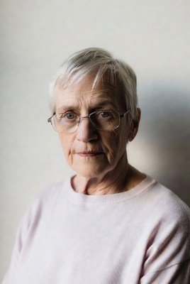 Older person with glasses and white hair