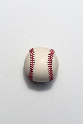 Baseball resting on white surface