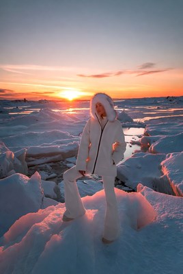 Woman in white outfit on ice