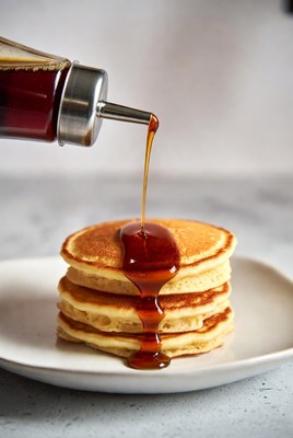 Syrup poured on stacked pancakes