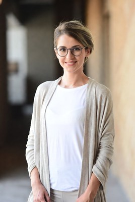 Woman smiling in a building corridor