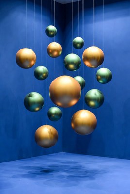 Hanging Gold Green Orbs Blue Wall