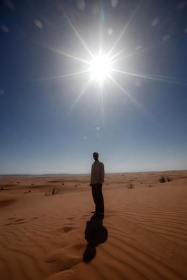 Man standing in desert under bright sun