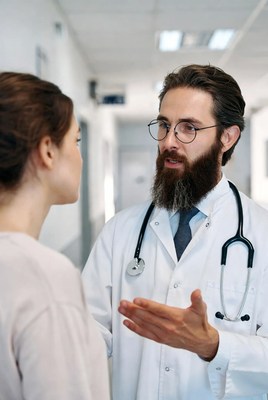 Doctor speaking to patient in hospital