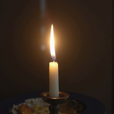 Candle flame in dark setting at night