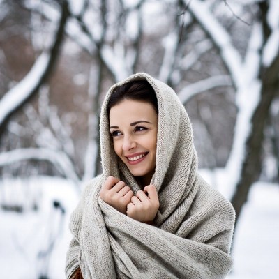 Smiling woman in snowy forest
