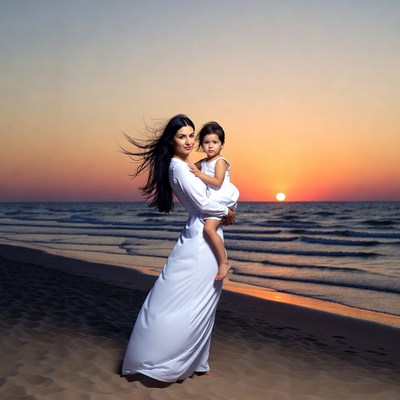 Mother and child on the beach at sunset